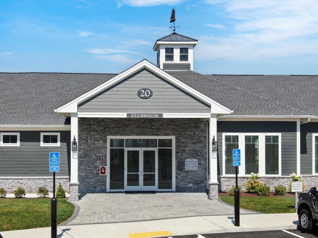 the front of a building with a car parked in front of it