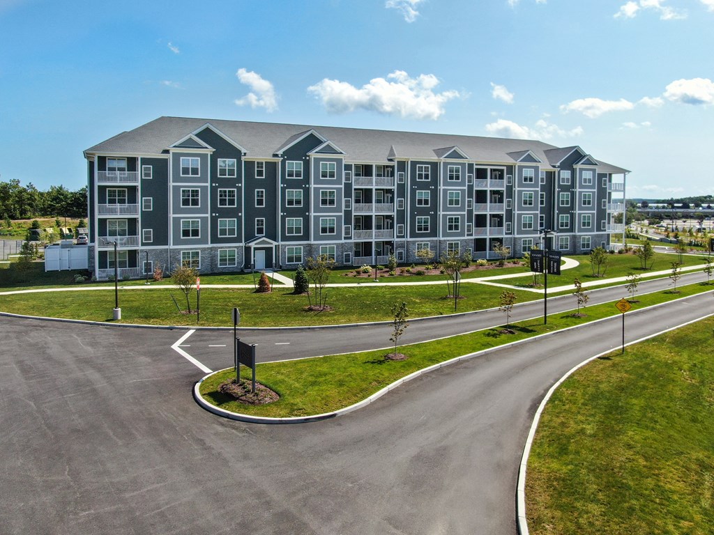 a large apartment building with a road in front of it