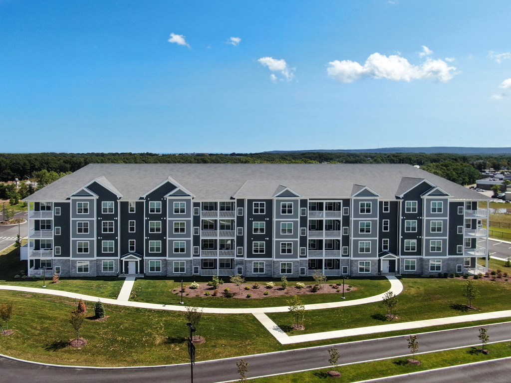 an aerial view of an apartment building with gray and black exterior