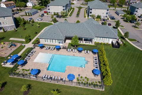 A large building with a pool in front of it.