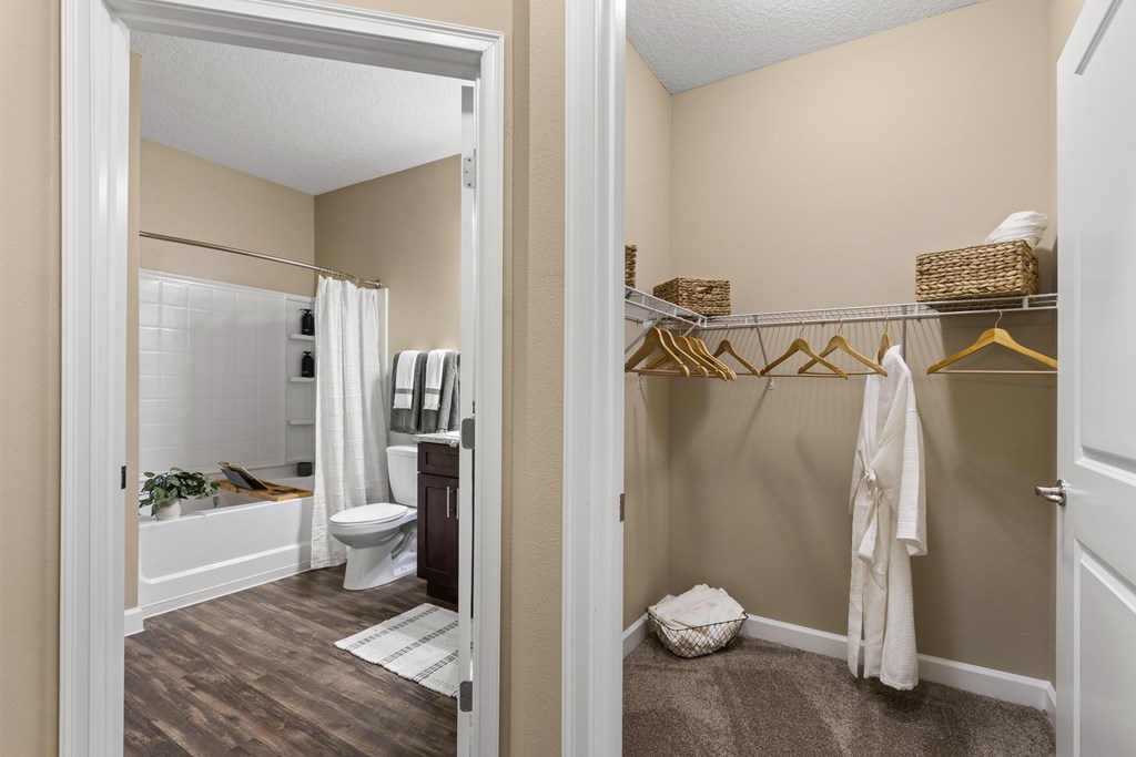 A white toilet is in a bathroom with a white shower curtain.