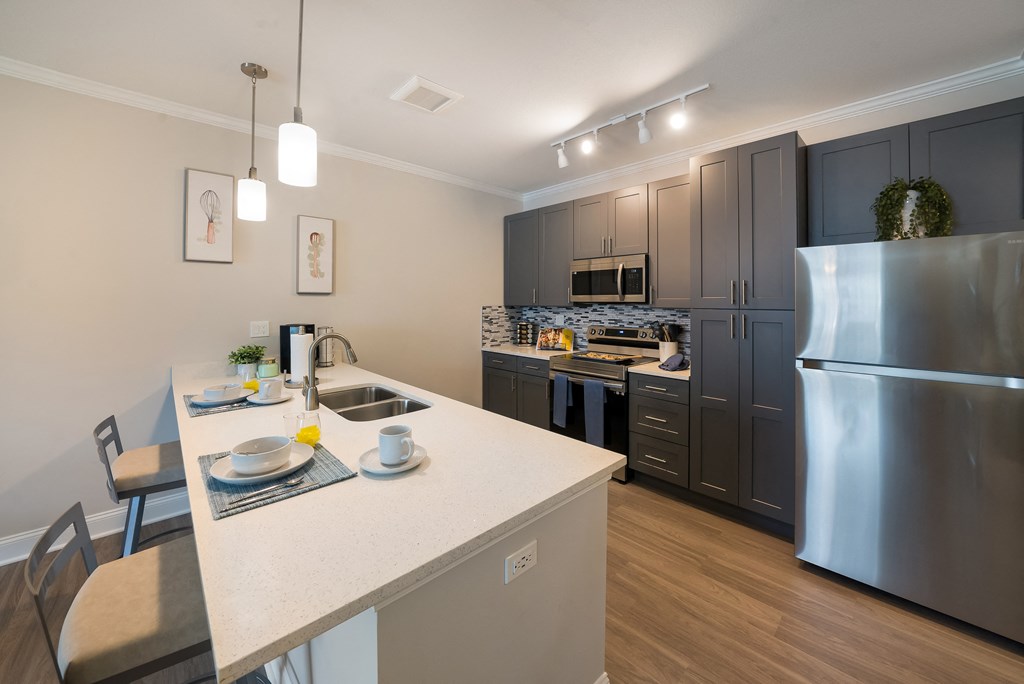 a kitchen with stainless steel appliances and a white counter top