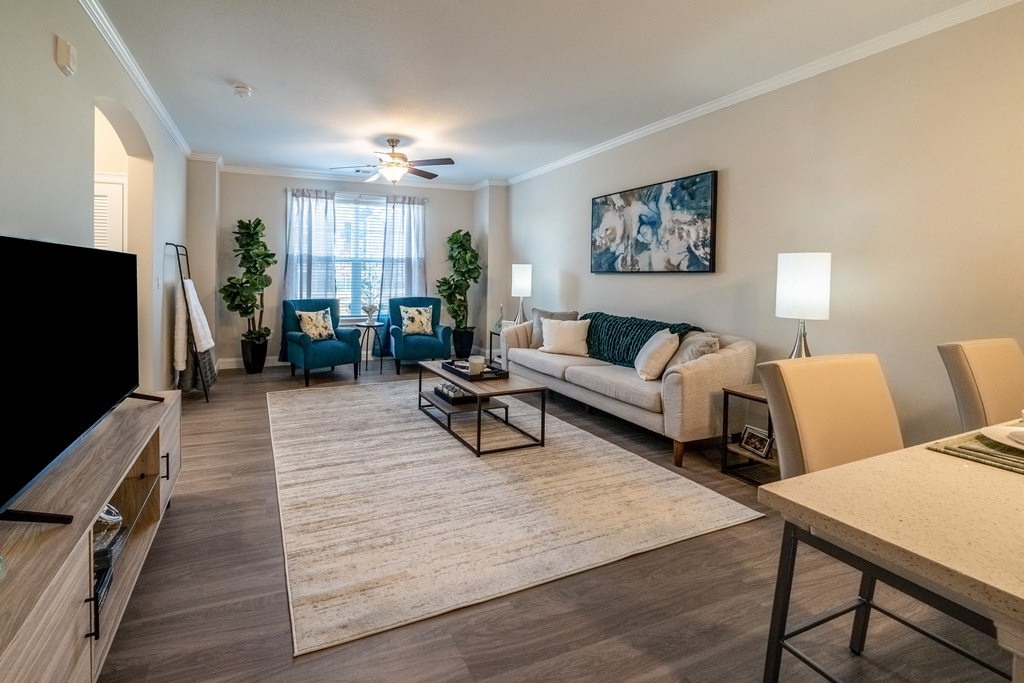 an open living room and dining room with a couch and chairs