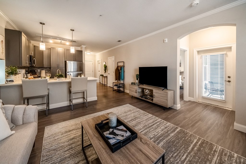 a living room and kitchen with a couch and a table