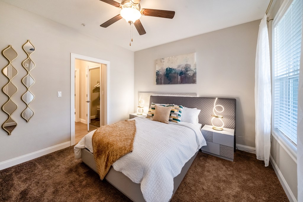a bedroom with a bed and a ceiling fan
