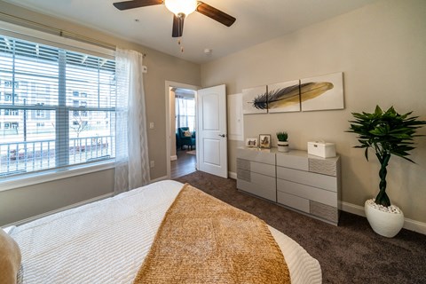 the preserve at ballantyne commons bedroom with a bed and a ceiling fan at The Oasis at Plymouth, Plymouth