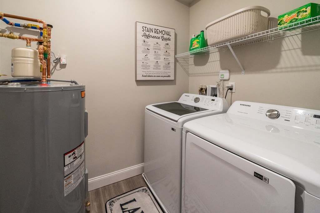the laundry room has a washer and dryer and a refrigerator