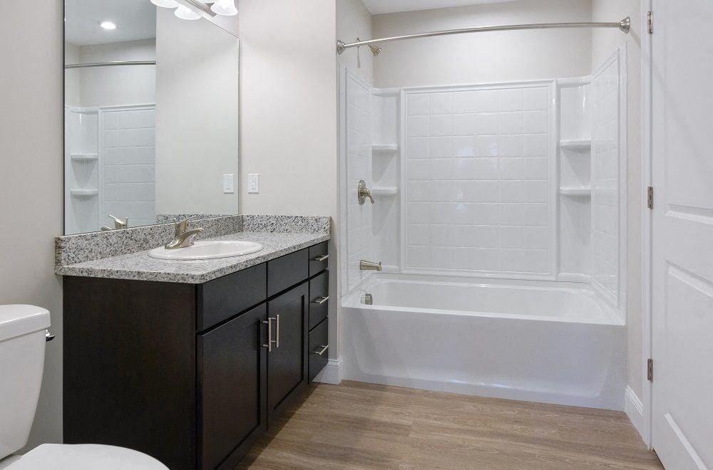 a bathroom with a sink and a shower and a toilet