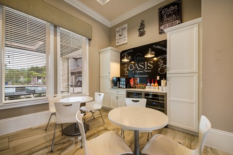 a dining room with tables and chairs and a bar at The Oasis at Highwoods Preserve, Tampa, 33647