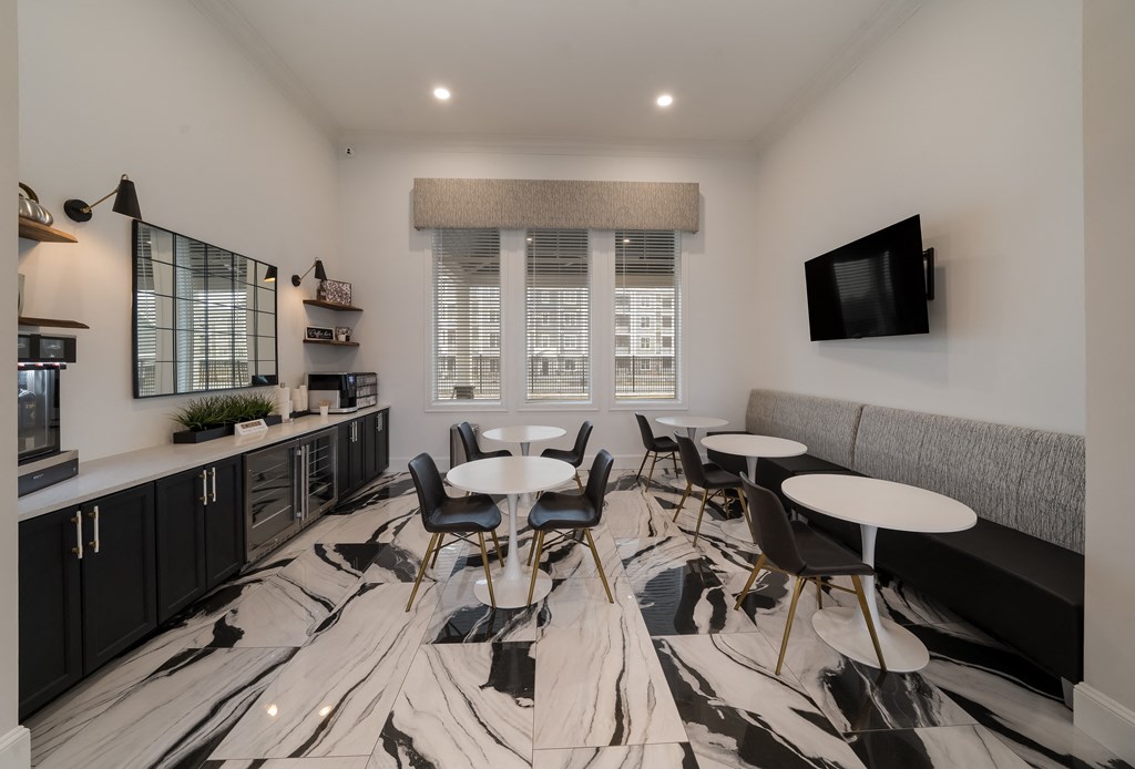 a meeting room with tables and chairs and a tv