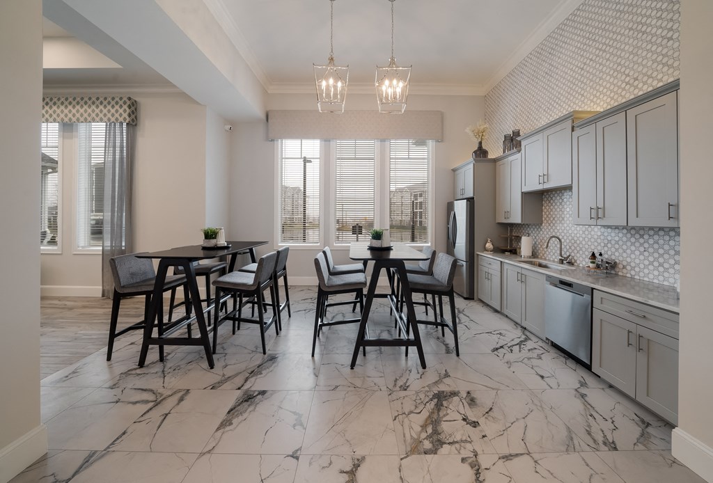 a kitchen and dining room with marble flooring and a table and chairs