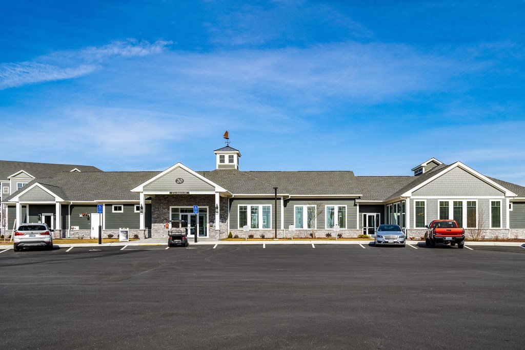 a large building with cars in a parking lot