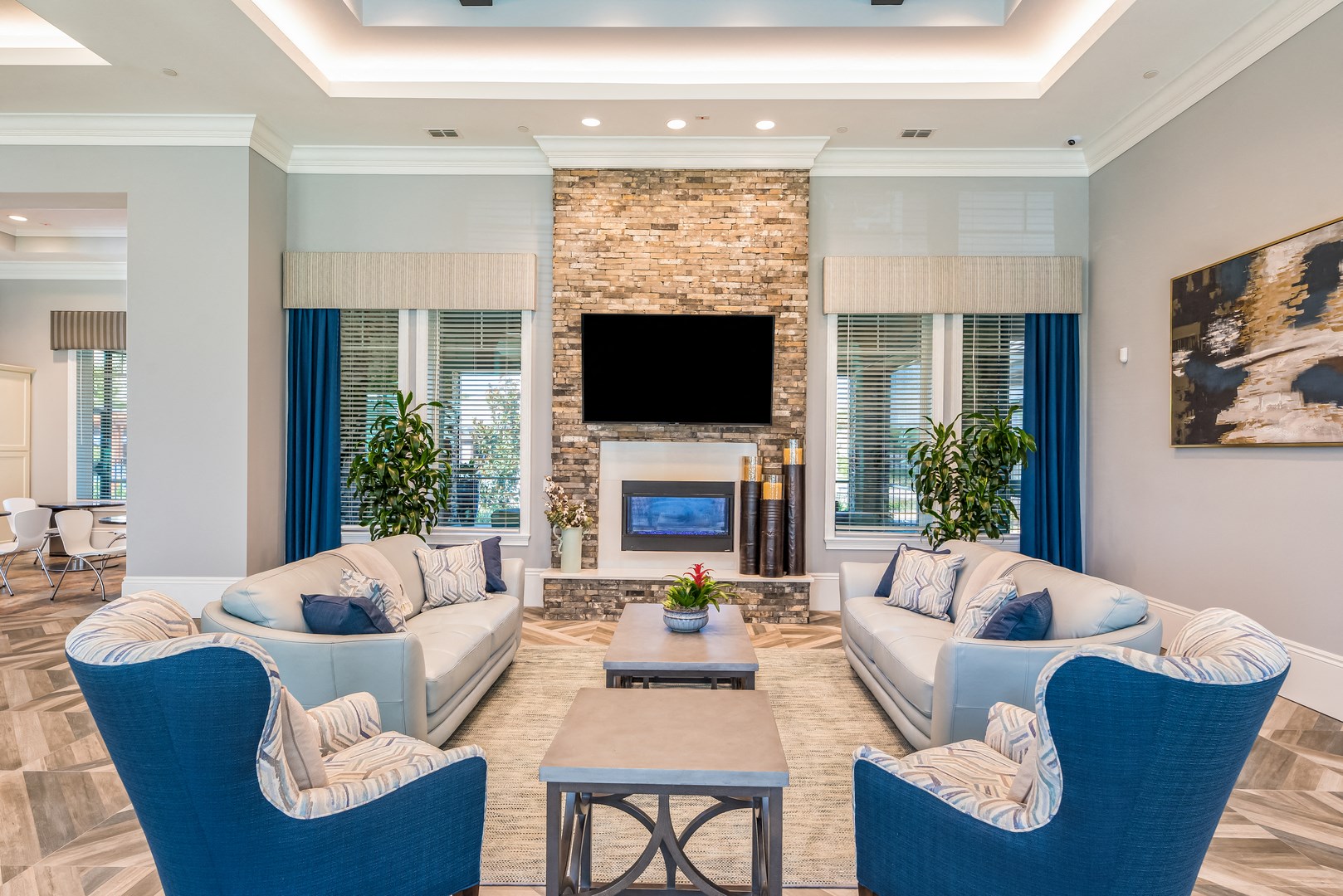 a living room with couches and a table and a fireplace