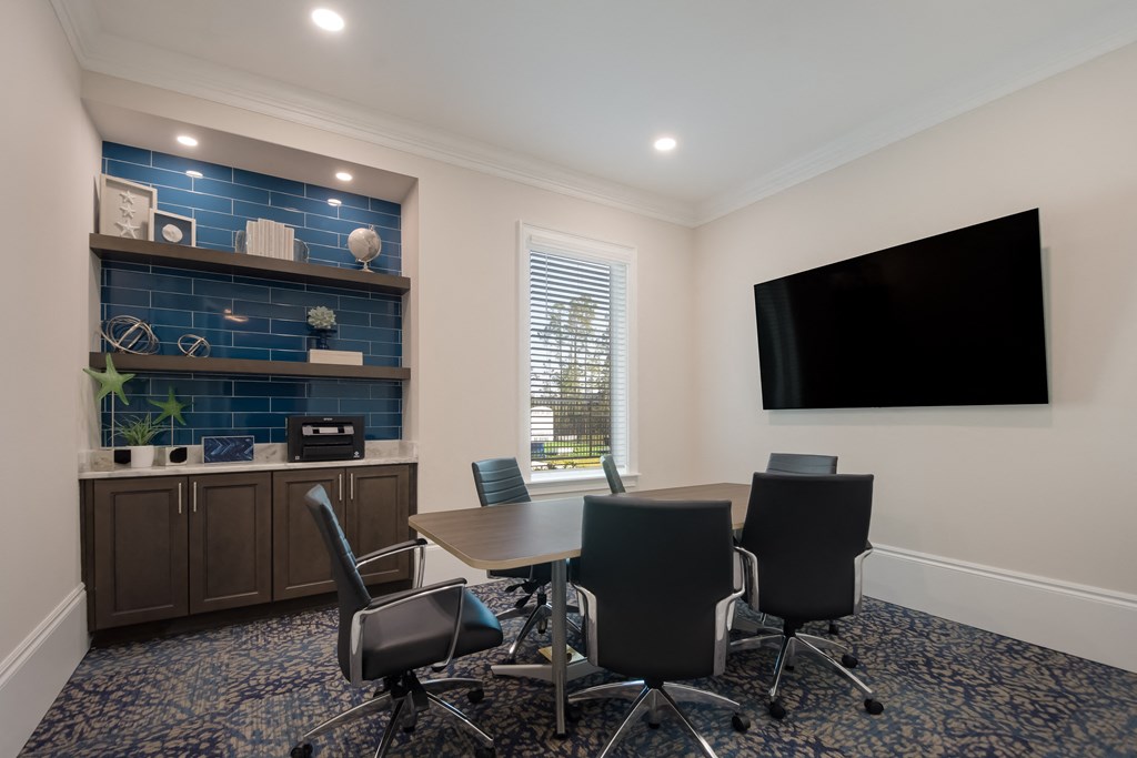 a meeting room with a table and chairs and a flat screen tv  at The Oasis at Manatee River, Florida