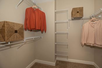 a walk in closet with racks and a shirt hanging on a rack at Level 25 at Cactus by Picerne Apartments, Las Vegas 89141
