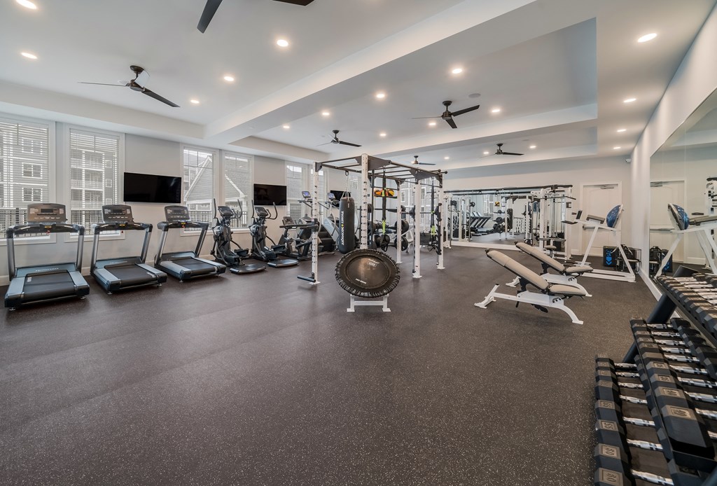 a gym with treadmills and other exercise equipment
