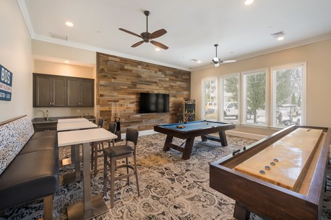 A room with a pool table and a fireplace.