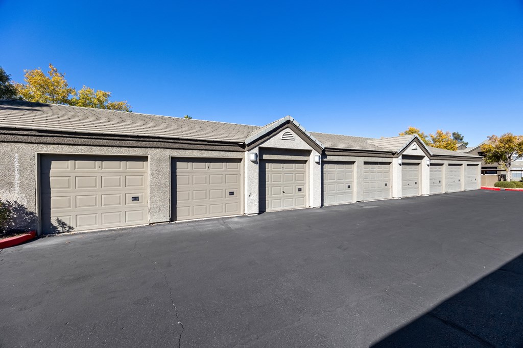 A row of garage doors are closed. at The Equestrian by Picerne Apartments, Henderson, NV