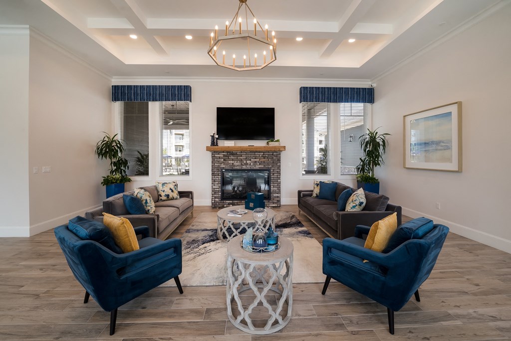 a living room with blue chairs and couches