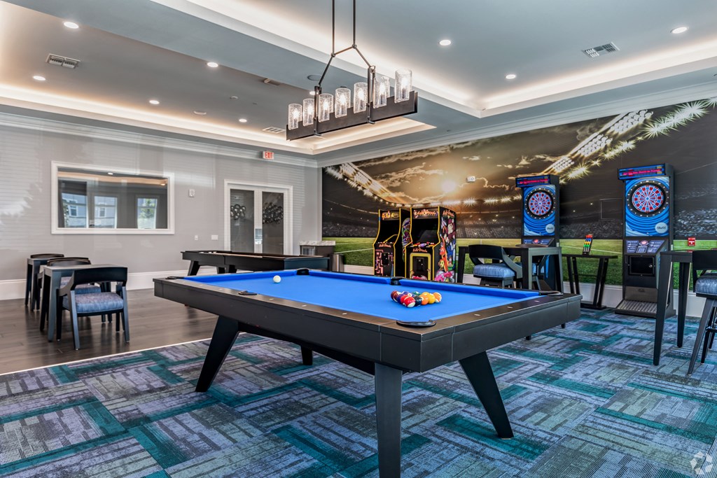 a game room with a pool table and arcade games at the sanctuary at kiawah at The Oasis at Manatee River, Bradenton, FL, 34211