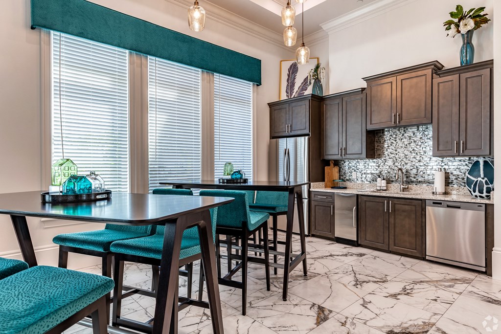 a kitchen with dark wood cabinetry and marble flooring at The Oasis at Manatee River, Florida