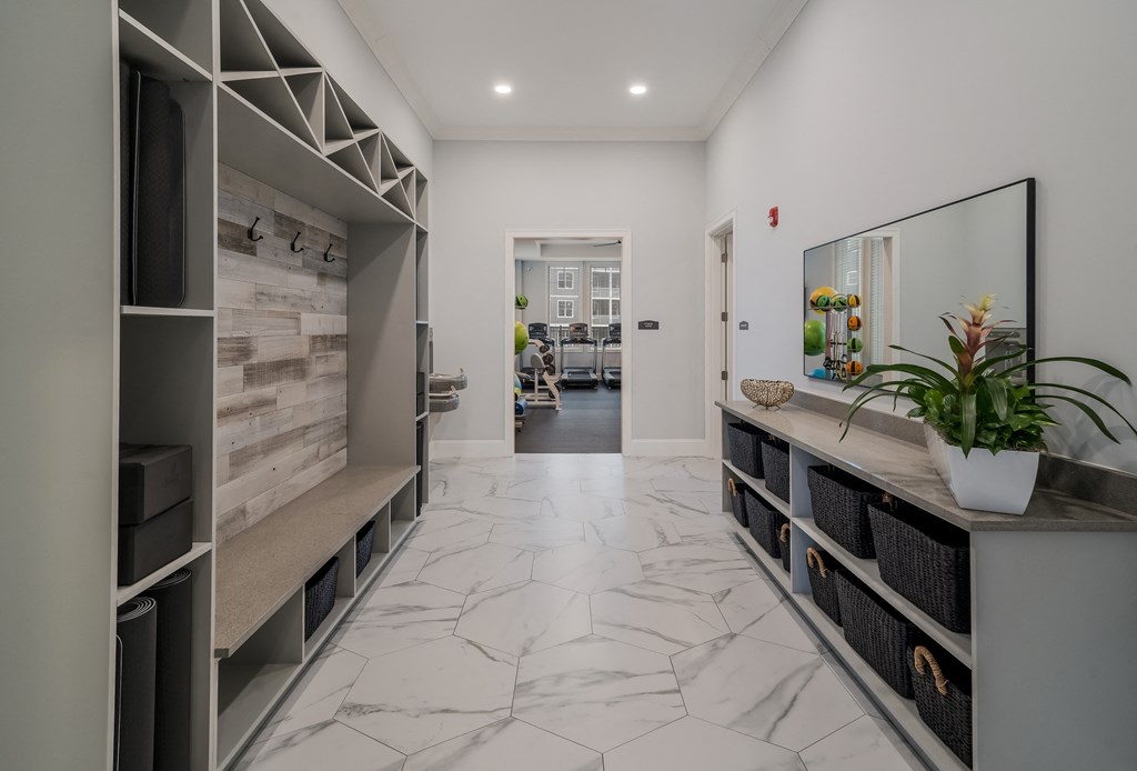 the living room has a marble floor and a large counter with a plant