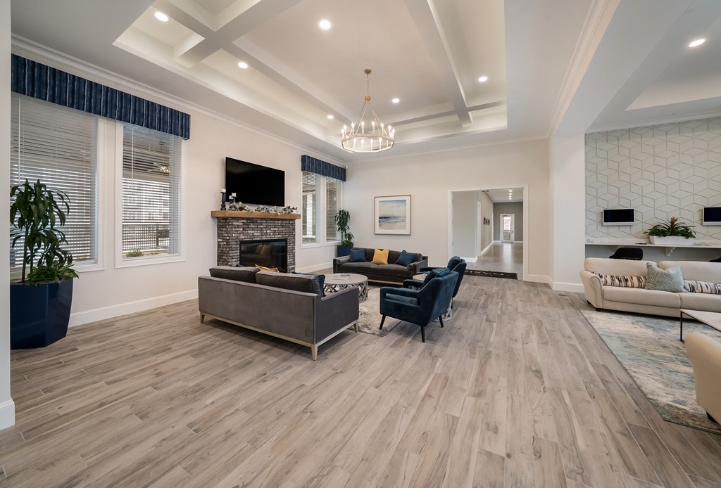 a living room with couches and chairs and a fireplace