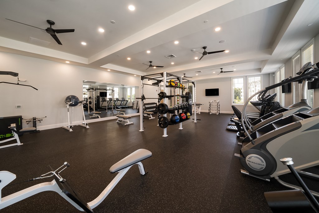 a gym with treadmills and other exercise equipment in a home