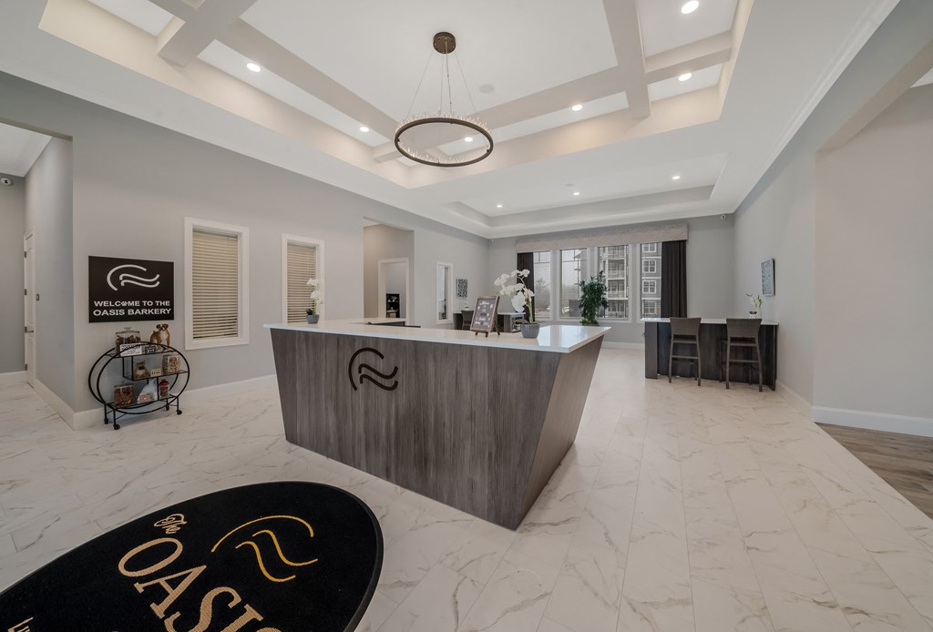 a large reception area with a large desk and a black rug