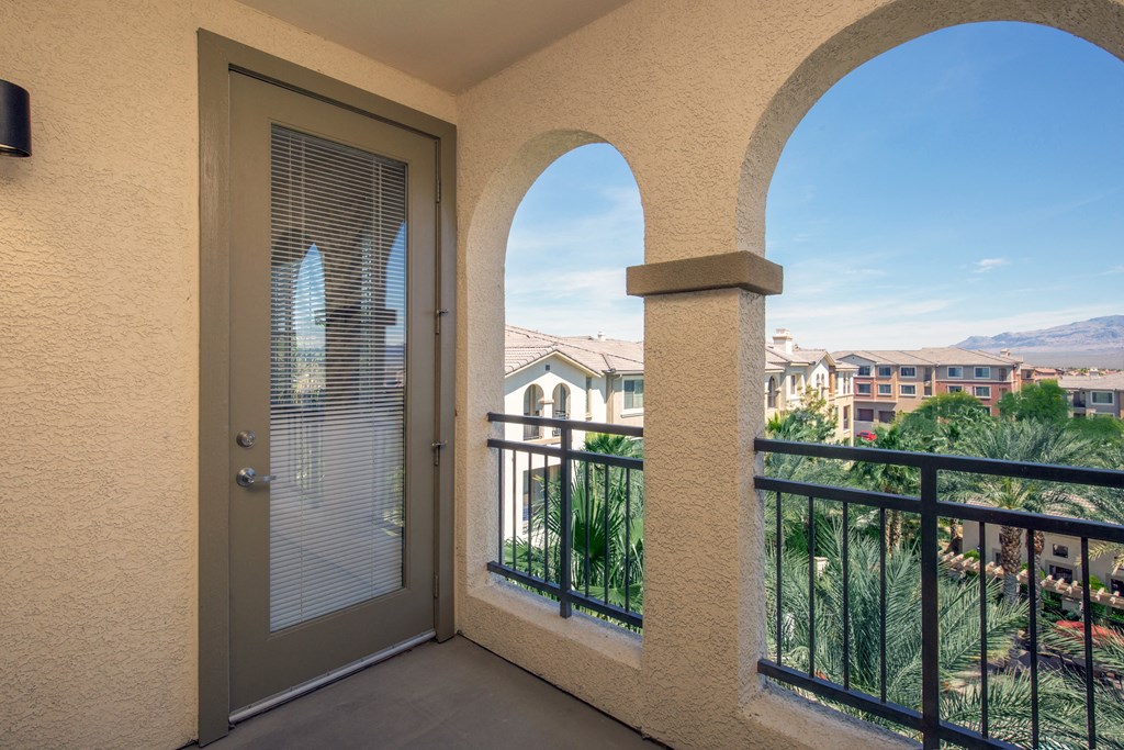 a balcony with a door and a view of the city