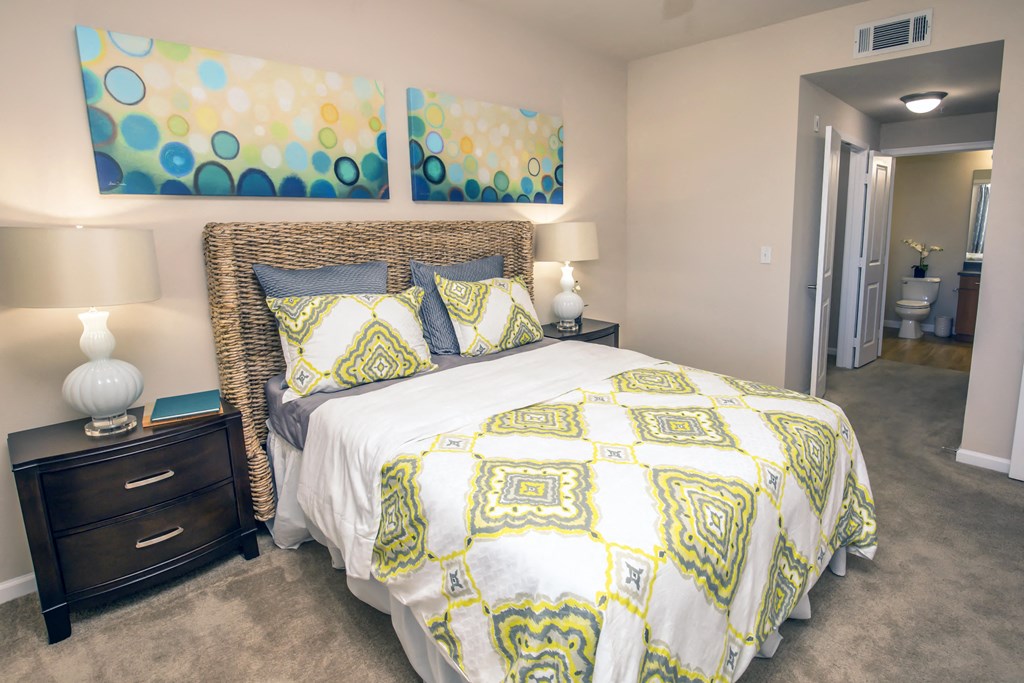 a yellow and white bed in a bedroom with a closet