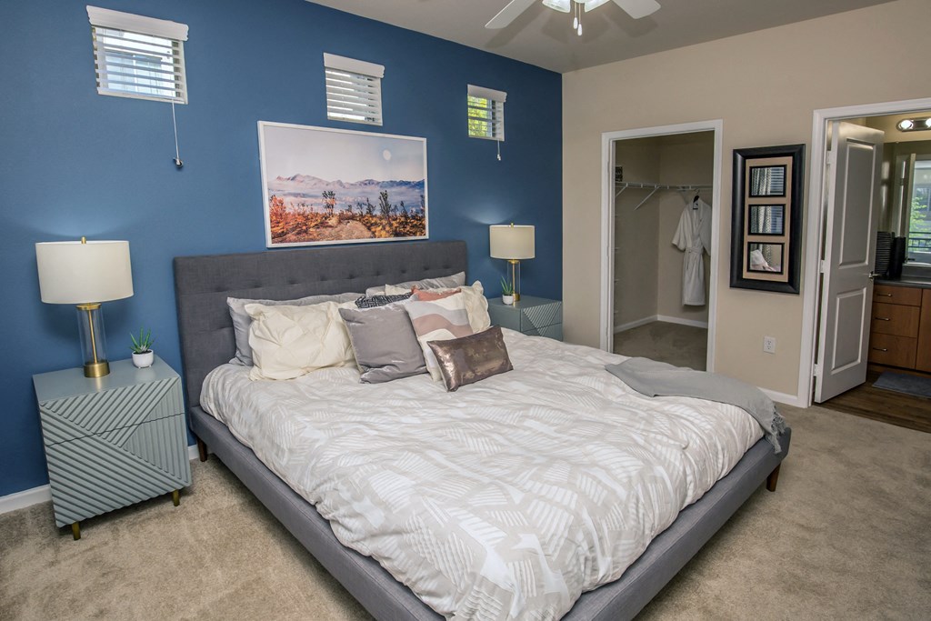 a bedroom with a large bed and a blue wall