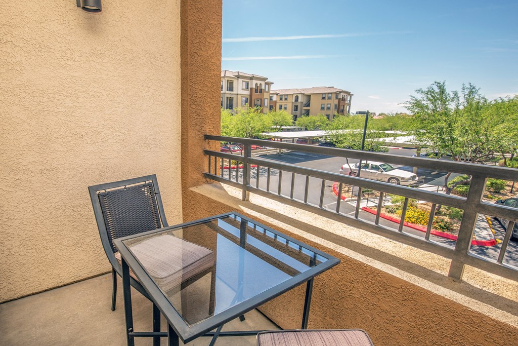 a balcony or terrace with a table and two chairs
