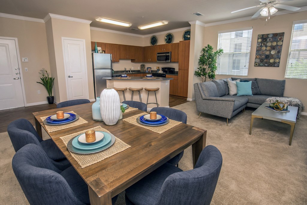 a dining room and living room with a table and chairs