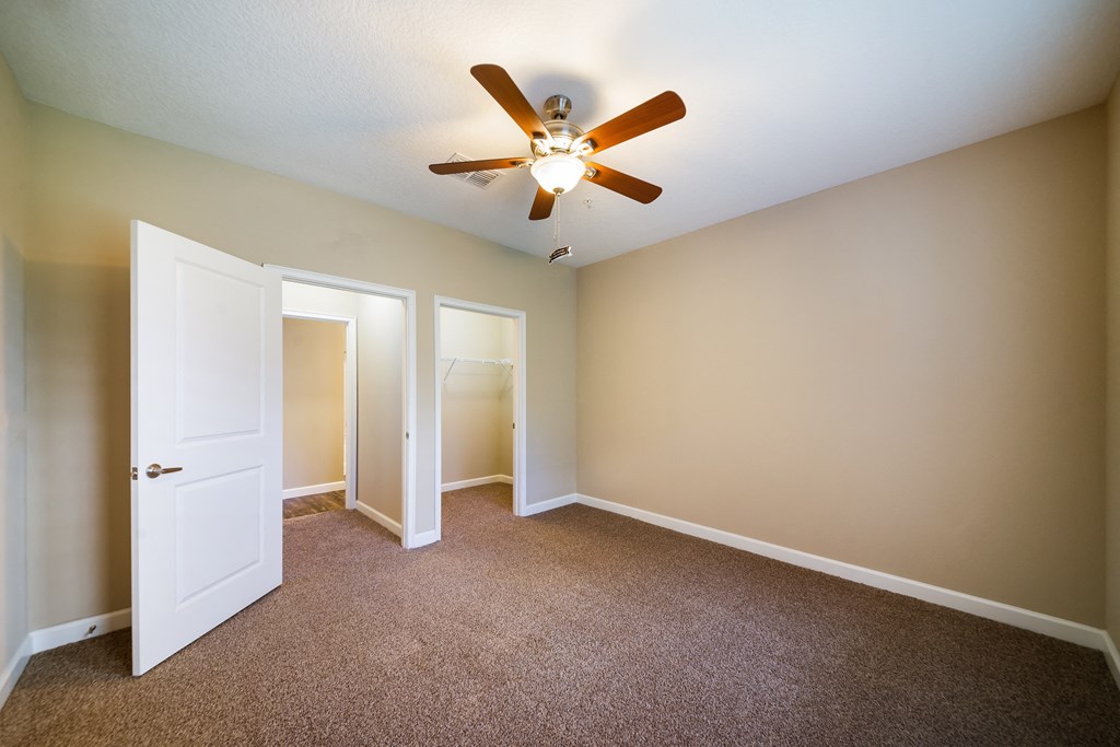 an empty room with a ceiling fan and a door to a closet at The Oasis at Highwoods Preserve, Florida, 33647