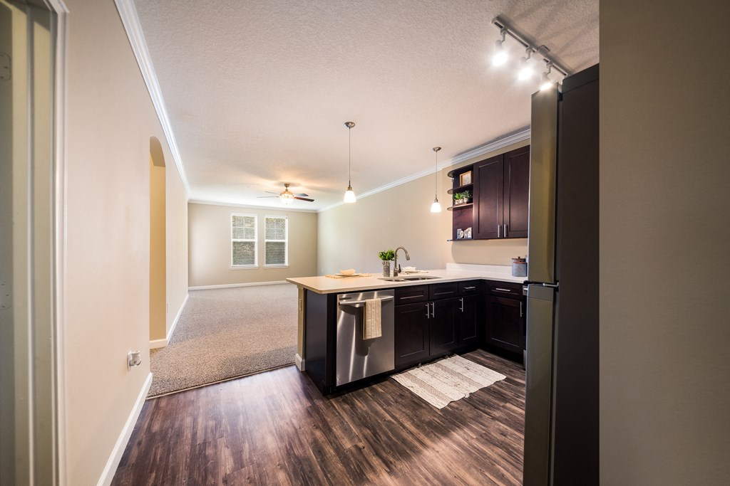 an open kitchen and living room with a refrigerator and a sink at The Oasis at Highwoods Preserve, Tampa, 33647