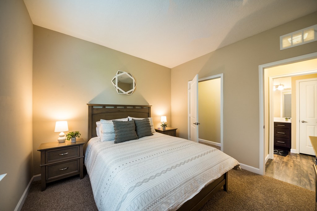 a bedroom with a large bed and a mirror at The Oasis at Highwoods Preserve, Tampa, FL