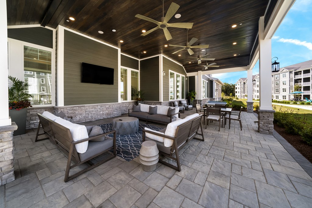 a covered patio with furniture and a tv