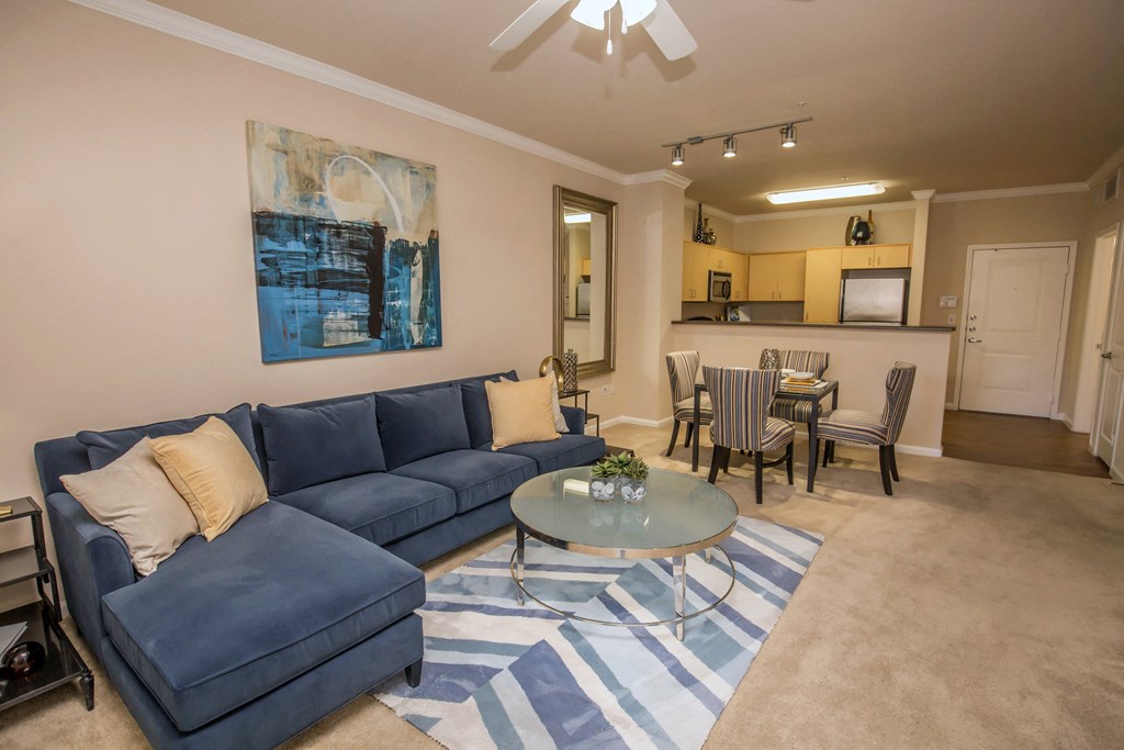 a living room with a blue couch and a coffee table