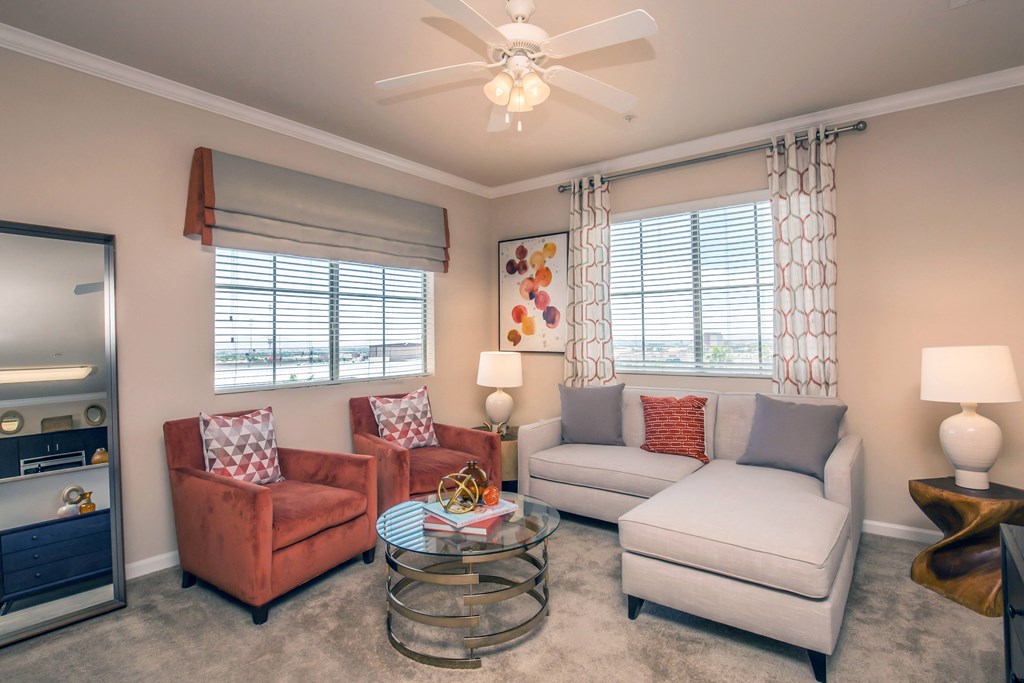 a living room with couches and chairs and a coffee table