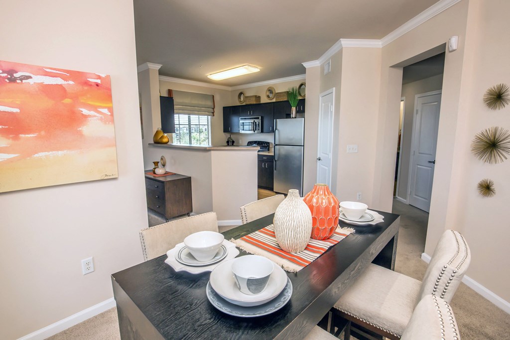 a dining room and kitchen with a table and chairs