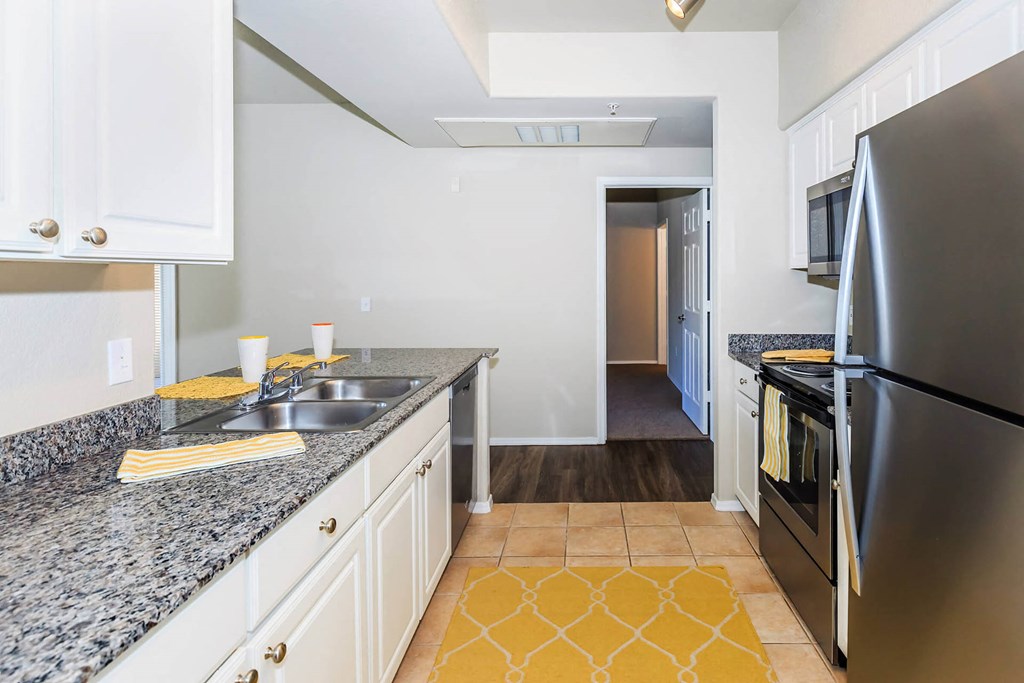 Kitchen appliances and cabinets with wooden flooring at The Aliante by Picerne, Scottsdale, AZ, 85259