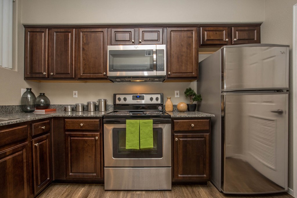 Kitchen with wooden cabinets1 at The Belmont by Picerne, Las Vegas, NV, 89183