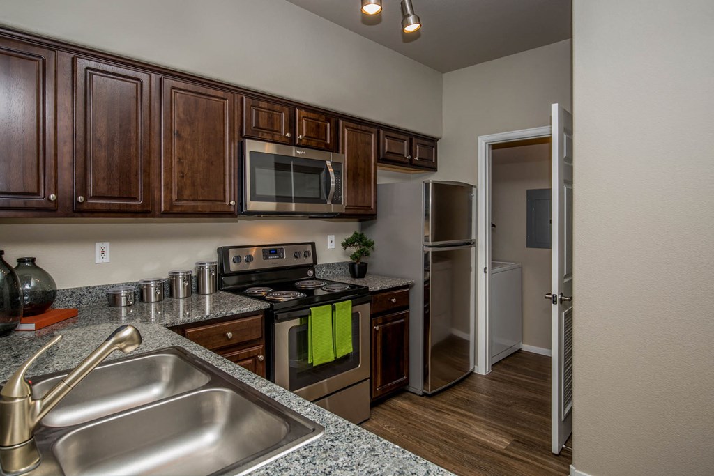 Kitchen with wooden cabinets at The Belmont by Picerne, Nevada, 89183