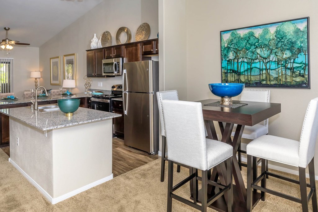 Kitchen wide view with cabinets and appliances with dining at The Cantera by Picerne, Las Vegas, NV, 89139