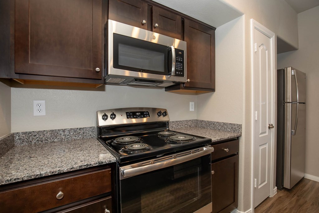 wooden cabinets and appliances in kitchen at The Cantera by Picerne, Las Vegas, NV, 89139