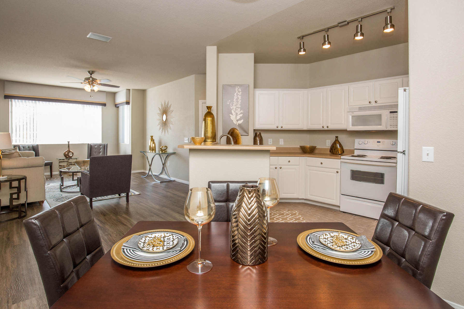 the view of a living room and kitchen with a dining table and chairs