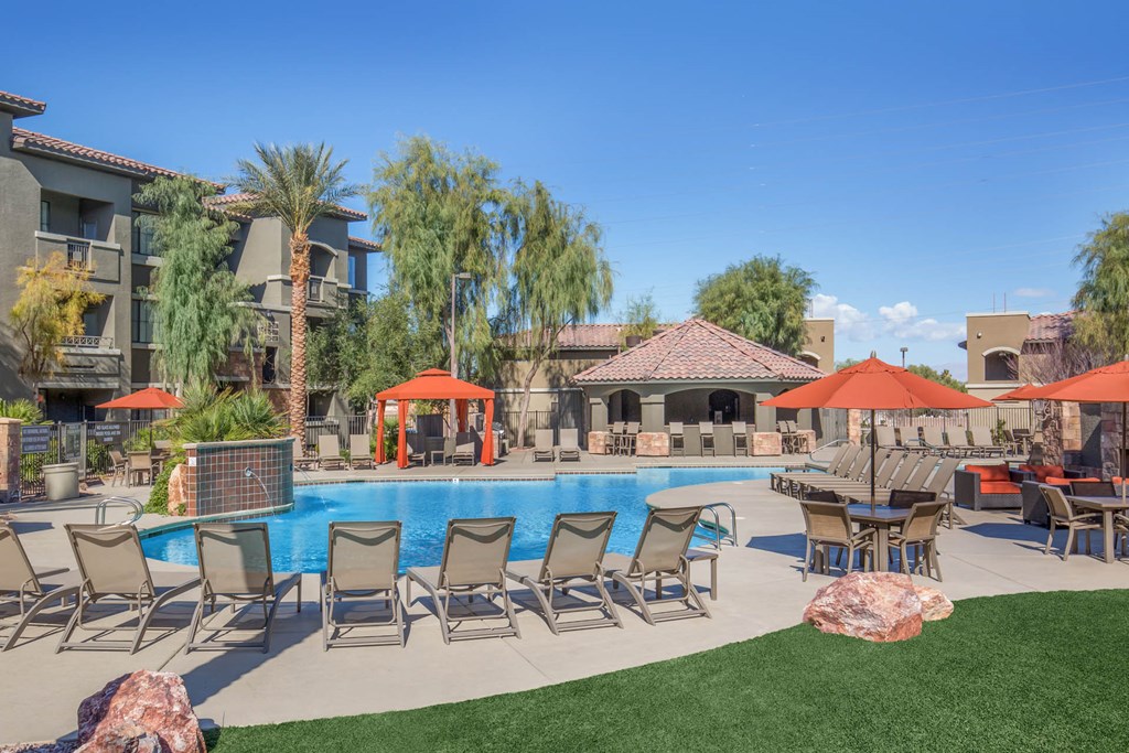 Swimming Pool With Lounge Chairs at The Passage Apartments by Picerne, Nevada