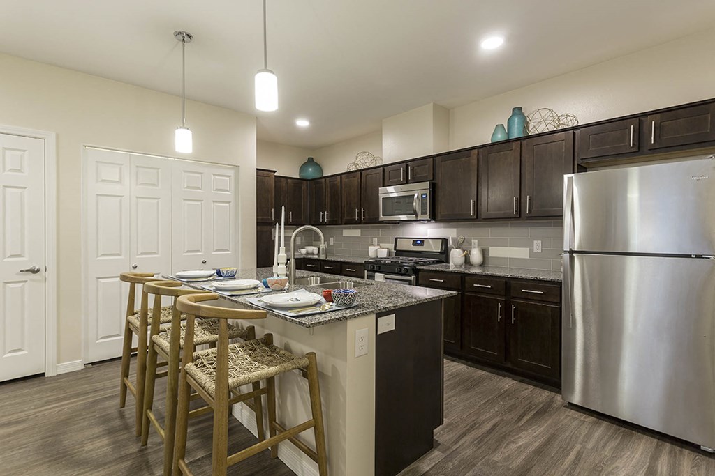 Kitchen with wooden cabinets and breakfast bar at The View at Horizon Ridge, Nevada, 89012