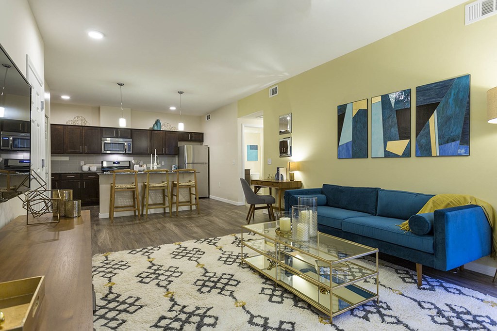 Living room with tv and couch and model kitchen at The View at Horizon Ridge, Henderson